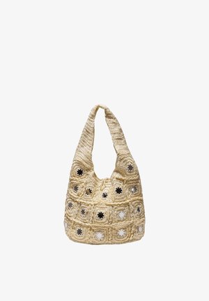 Sac à bandoulière beige en crochet avec des motifs carrés et de petits miroirs circulaires réfléchissants au centre de chaque carré.