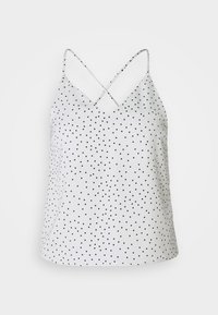 Witte mouwloze top met zwarte stippen, voorzien van spaghettibandjes die op de rug kruisen en een iets loszere pasvorm. Zacht, soepel materiaal.