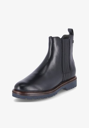 Stivale Chelsea in pelle nera con pannelli elastici laterali, punta rotonda e suola in gomma marrone a contrasto con motivo a zigzag.