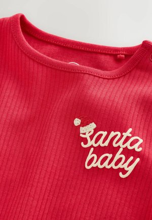 Red ribbed long-sleeve top with a round neckline featuring white embroidered text "Santa baby" and a small Santa hat accent.