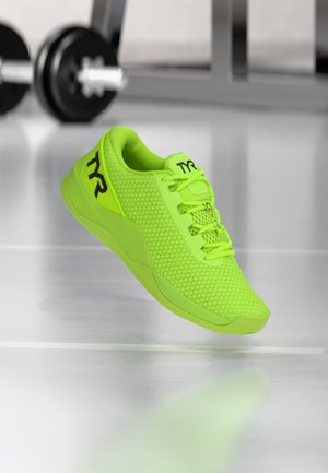 Neon green athletic shoe featuring a textured mesh upper, lace-up design, and a prominent logo. Lightweight rubber sole with cushioning elements.