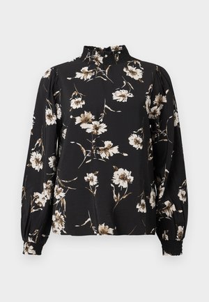 Melna garā piedurkne blūze ar augstu savāktu apakšmalu, kas piemīt ziedu raksts baltā un bēšā krāsā, teksturēts audums un pieguloši aproces.