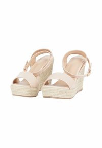 Sandali con zeppa in beige chiaro con suola in juta testurizzata, punta aperta e cinturino regolabile alla caviglia. Parte superiore in tessuto liscio con design minimalista.