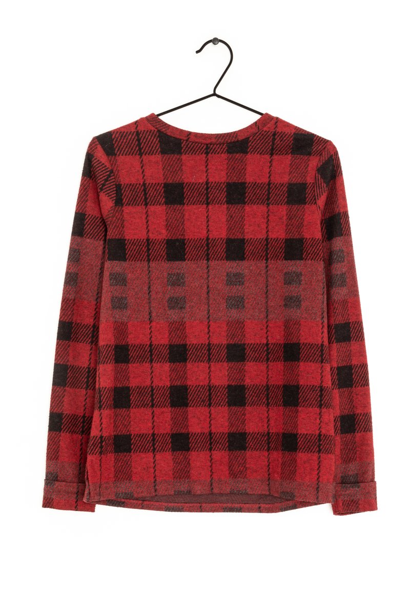 Chemise à manches longues en flanelle à carreaux rouges et noirs, en tissu tricoté, avec un col rond, un ourlet droit et des fentes sur les côtés, suspendue à un crochet noir.