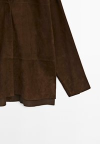 Brown suede jacket with long sleeves and a relaxed fit, featuring a seam detail and a slightly longer back hem.