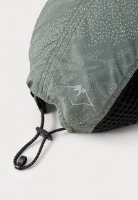 Green patterned outdoor cap with a drawstring closure, featuring a black mesh underside and a reflective logo detail.