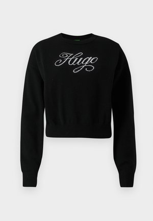 Sweatshirt noir court en tissu tricoté, avec un logo "Hugo" brodé en argent sur la poitrine et des poignets côtelés.
