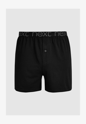 Boxers noirs en coton doux avec une ceinture élastique arborant le mot "next" répété en gris, fermeture à bouton à l'avant et coupe décontractée.