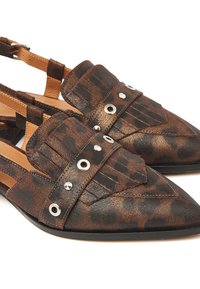 Brown and black leopard print flats with pointed toe, textured material, and decorative straps featuring silver studs and accents.