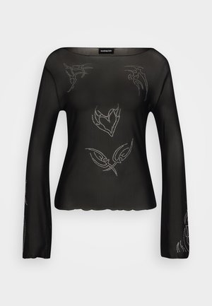 Bluză lungă, cu mânecă lungă, din material transparent, de culoare neagră, cu detalii decorative argintii și margine ondulată. Textură netedă, cu o croială lejeră și decolteu larg.