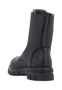 Botín de cuero negro con un forro texturizado gris, puntera redondeada y suela de goma con un sutil logo grabado en el lateral.