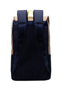 Tiili ja beez seljakott pehmendustega rihmadega, ülemise käepideme ja sileda tekstuuriga. Omab voolujoonelist kuju ja minimalistiilist disaini.