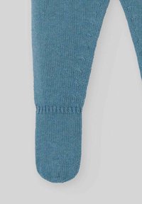 Leggings en tricot bleu avec une texture lisse, design de jambe cintrée et poignet côtelé. Présente de petites coutures décoratives sur le côté.
