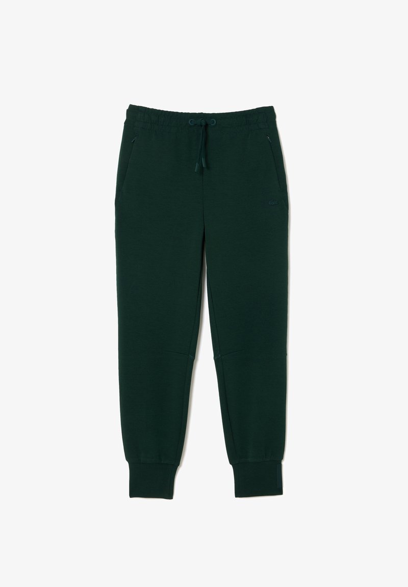 Dunkelgrüne Sweatpants mit einem elastischen Bund, Kordelzug, Seitentaschen und gerippten Bündchen. Hergestellt aus einem weichen Baumwollmischgewebe.