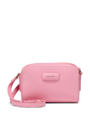 Pink synthetic leather crossbody bag with zip closure, gold hardware accents, and a logo plaque on the front. Includes a detachable strap.