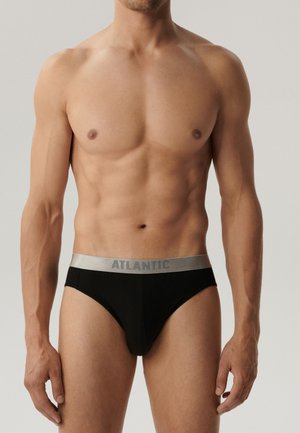 Czarne kąpielówki z srebrnym pasem z napisem "ATLANTIC". Materiał wydaje się gładki i elastyczny, dopasowując się do ciała.