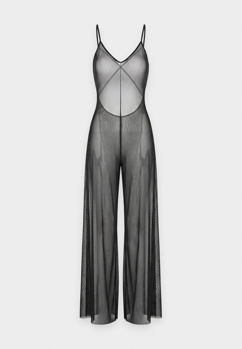Combinaison noire transparente à jambes larges, avec bretelles spaghetti et un profond décolleté dans le dos, en tissu mesh léger.
