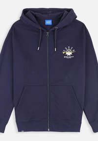 Molleton zippé bleu marine avec capuche, poches avant et un imprimé graphique avec "Oxbow Surf Supply" en jaune et blanc. Matière en coton doux.