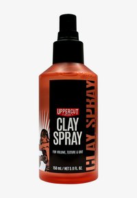 Spray per capelli Uppercut Deluxe in una bottiglia arancione opaca con un tappo a pompa nera. Presenta un'etichetta audace in bianco e nero, che dettaglia il volume e la texture.