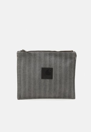 Gray zippered pouch made of herringbone fabric with a black logo patch. Features a flat, rectangular shape and visible stitching accents.