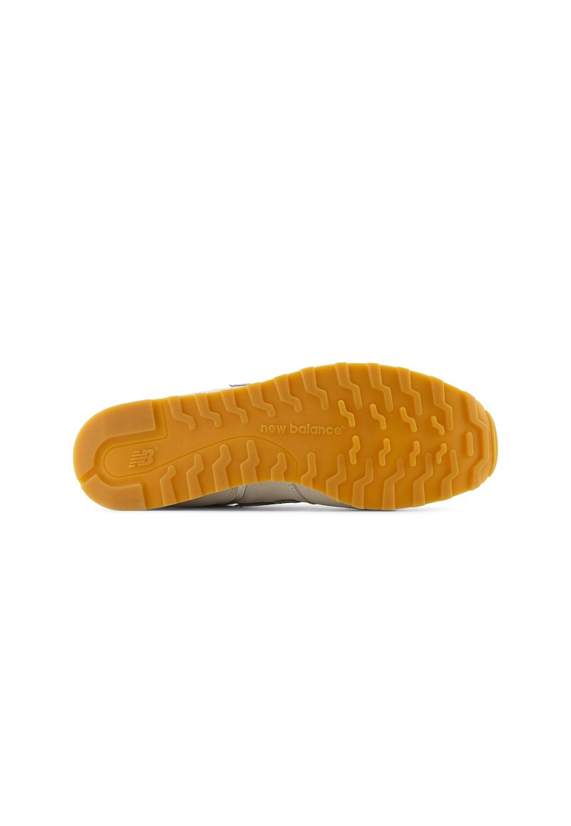 Suela de zapato con patrón de tracción. Material de goma amarilla. Presenta un logo en relieve y ranuras. Parte superior de color neutro para versatilidad.