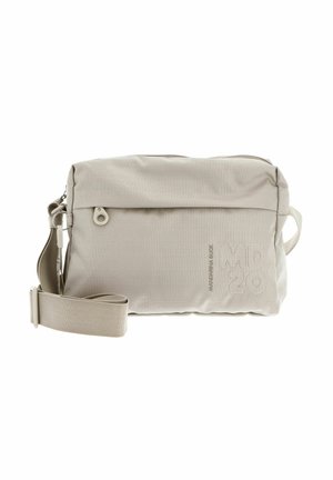 Beige crossbody bag with a textured fabric, top zip closure, adjustable strap, and embossed logo on the front. Sturdy design for daily use.