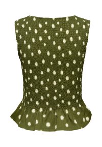 Top sans manches vert olive à pois blancs irréguliers, corsage froncé et ourlet à volants évasé.