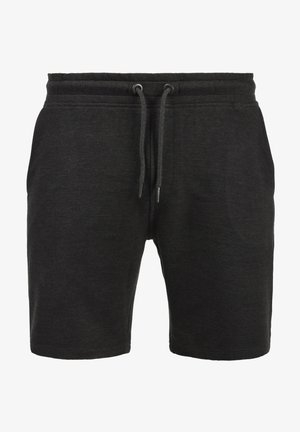 Shorts de sudation noirs en tissu doux et texturé. Comprend une ceinture élastique avec cordon de serrage et des poches latérales. Longueur mi-cuisse.