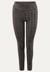 Mustat legginsit, joissa on geometrian muotoinen kuvio ja beigejä yksityiskohtia, valmistettu joustavasta kankaasta, joka luo istuvan ilmeen ja sileän tuntuman.