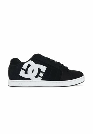Czarny niski sneaker z białą grubą podeszwą i dużym białym logo DC po boku, z zapięciem na sznurowadła i gwiazdkowym detalem.