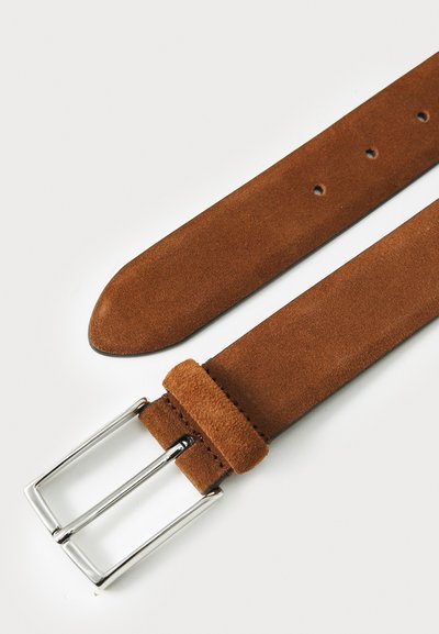 Brauner Wildledergürtel mit flachem Design, ausgestattet mit einer silbernen Metallschnalle und mehreren Löchern zur Anpassung. Texturierte Oberfläche über das gesamte Produkt.