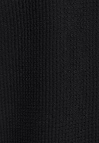 Black textured fabric with a ribbed design. The surface is soft and plush, with a consistent pattern throughout.