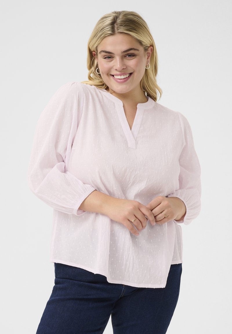 Helles rosa, strukturierte Bluse mit Mandarin-Kragen und langen Puffärmeln, die subtile gepunktete Muster und einen entspannten Schnitt bietet.
