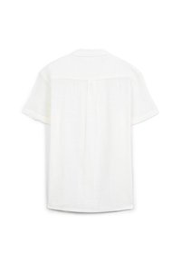 Camicia bianca a maniche corte con vestibilità rilassata, tessuto in lino morbido e dettaglio con spallina dietro e cucitura centrale.