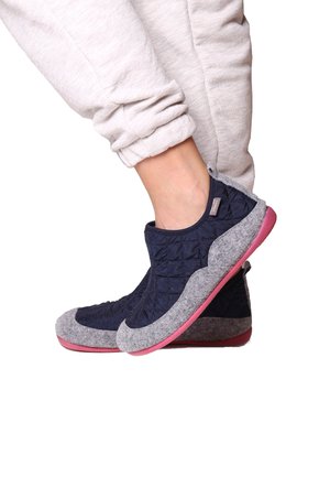 Blue quilted fabric slip-on shoes with grey felt accents and a pink rubber sole, featuring a pull tab and rounded design.