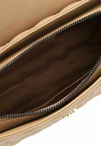 Borsa a tracolla trapuntata color cammello con interno beige, zip nera con dentatura in metallo e inserti in oro. Spaziosa con più scomparti.