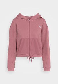 Sweat à zip court en rose poussiéreux, fabriqué en tissu doux et texturé. Il possède une poche frontale, un ourlet avec cordon de serrage et un logo blanc sur la poitrine.