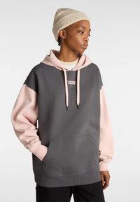 Sudadera con capucha en gris y rosa, hecha de tela suave. Presenta un bolsillo frontal, cordón negro y un logo de Vans en el pecho.