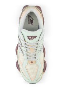 Light green and beige sneaker with a mesh upper, rounded shape, and grey laces. Features a maroon accent and logo. Textured outsole for grip.