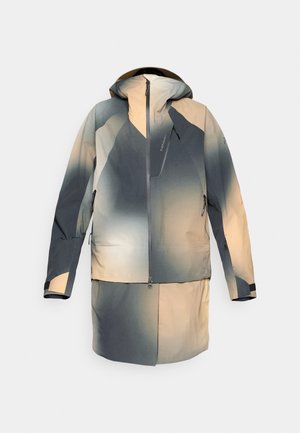 Veste imperméable dans des nuances de gris et de beige, dotée d'une capuche, d'une fermeture éclair sur le devant et de poches, avec un design en dégradé de couleurs.