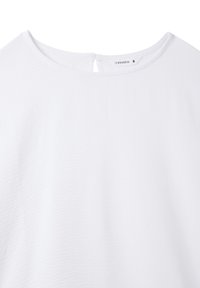 Blusa bianca con un tessuto leggermente texturizzato, scollatura rotonda e un piccolo apertura a forma di chiave sul retro. L'etichetta mostra "Terranova" e taglia S.
