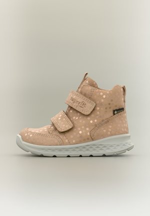Bottine enfant rose clair à pois brillants, deux brides velcro, semelle blanche et étiquette Gore-Tex sur fond uni.