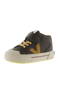 Dark green toddler high-top sneaker with yellow patterned laces, a velcro strap, yellow side detail, and a white sole with a purple stripe.