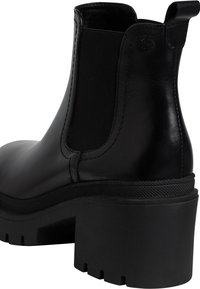 Botas Chelsea de cuero negro con paneles laterales elásticos, diseño de punta redonda y un tacón de goma grueso con una superficie texturizada.