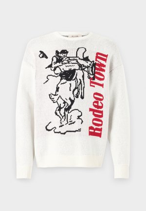 White knitted sweater featuring a black and red graphic design with a cowboy and horse, and text "Rodeo Town" in bold red letters.