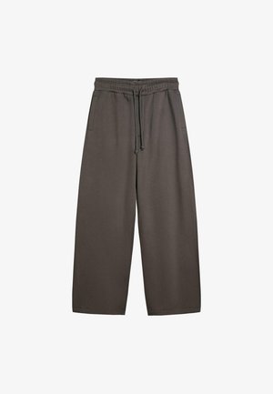 Tamno smeđe široke trenirke od mekog tkanja. Imaju elastični pojas s vezicama i bočne džepove. Glatka tekstura.