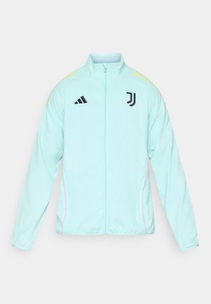Light blue windbreaker jacket with black Adidas and Juventus logos, yellow accents on shoulders, full-length zip, and pink side piping.
