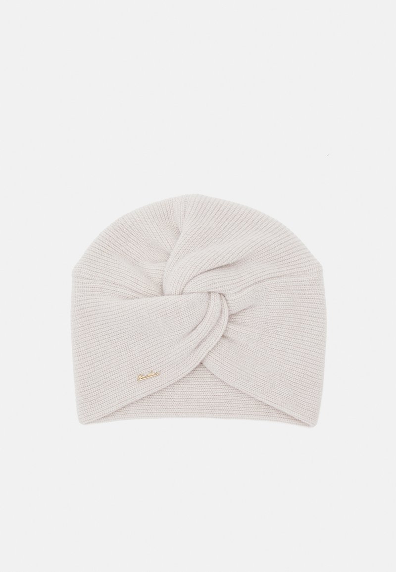 Knit beanie in light beige, featuring a twisted design at the front, with a small gold logo accent on the side.