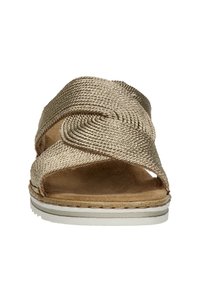 Woven gold-toned sandals featuring a cross-strap design, soft suede insole, and a white rubber sole with subtle stitching detail.