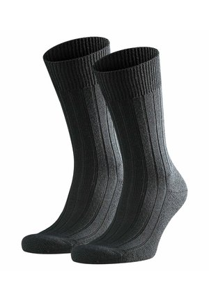 Calcetines de algodón negros con costillas, con refuerzo en el talón y en la puntera, mostrando una superficie texturizada y un diseño de longitud media hasta la pantorrilla.